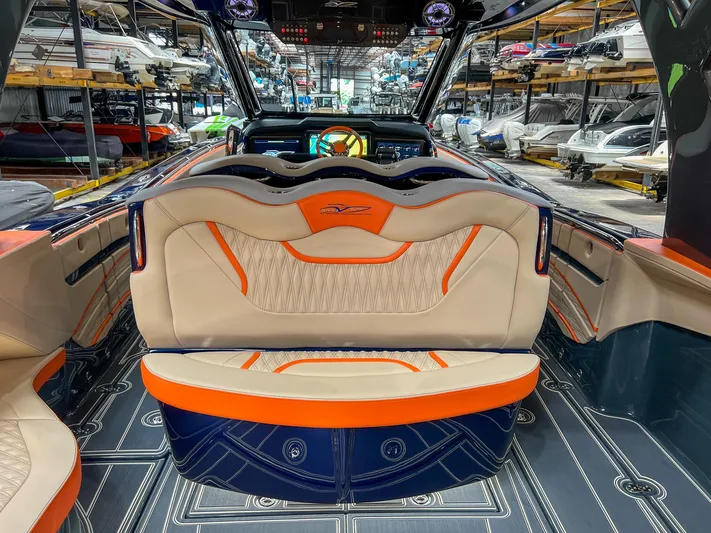 Thunder Struck Yacht Photos Pics 2024 MTI V42 boat interior with orange and beige seating, sleek design, and modern dashboard.