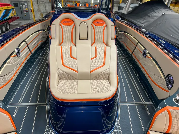 Thunder Struck Yacht Photos Pics 2024 MTI V42 boat interior with luxurious seating and vibrant orange accents.