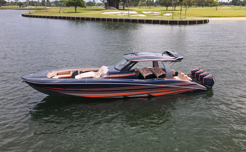 Thunder Struck Yacht Photos Pics 2024 MTI V42 luxury boat with sleek design and powerful engines on a calm waterway.