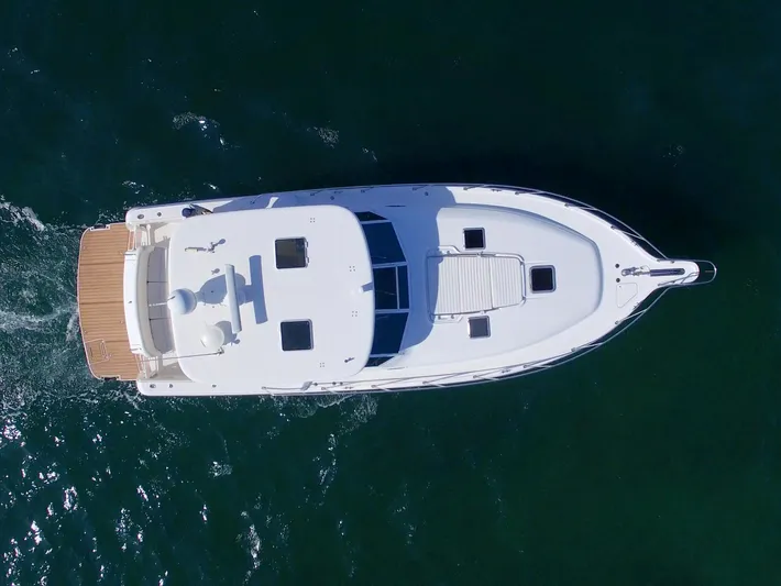 Ohana Yacht Photos Pics Aerial view of 2003 Tiara Yachts 4000 Express cruising on water.