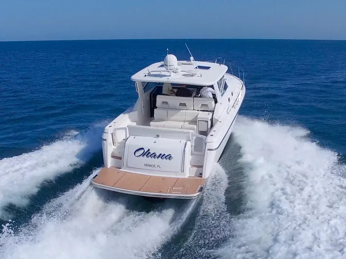 Ohana Yacht Photos Pics 2003 Tiara Yachts 4000 Express cruising on open water, rear view.