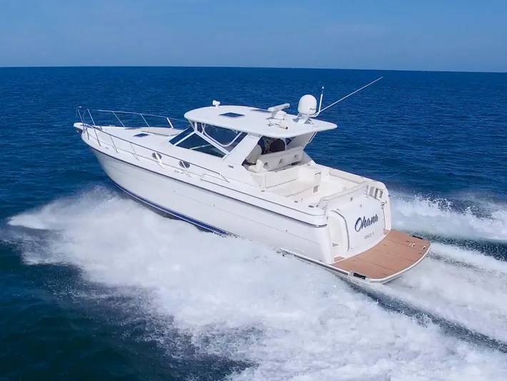 Ohana Yacht Photos Pics 2003 Tiara Yachts 4000 Express cruising on open water, rear view.