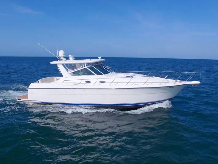 Ohana Yacht Photos Pics 2003 Tiara Yachts 4000 Express cruising on open water under clear blue skies.