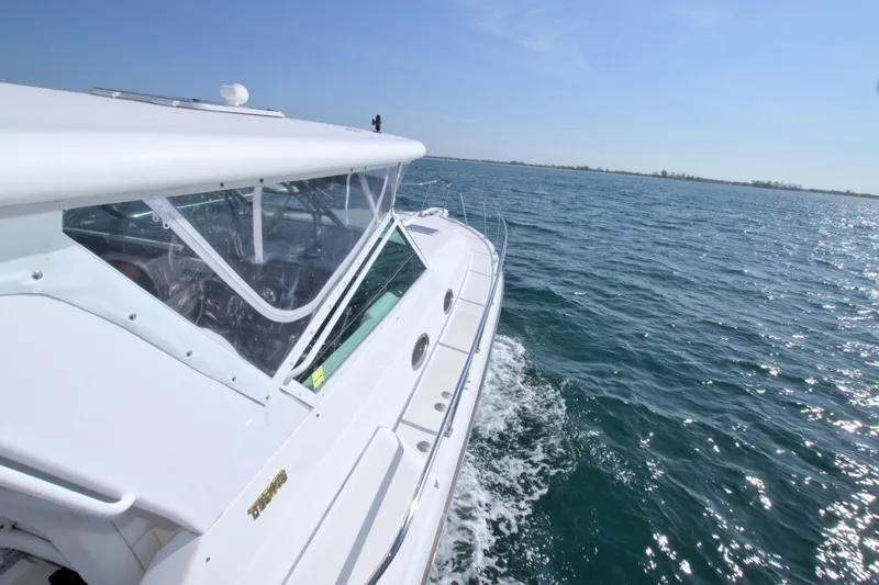 Ohana Yacht Photos Pics 2003 Tiara Yachts 4000 Express cruising on open water under clear skies.