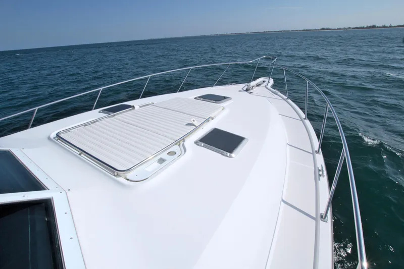 Ohana Yacht Photos Pics 2003 Tiara Yachts 4000 Express cruising on open water, showcasing sleek deck design.