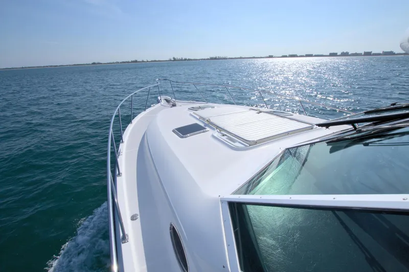 Ohana Yacht Photos Pics 2003 Tiara Yachts 4000 Express cruising on open water under clear skies.