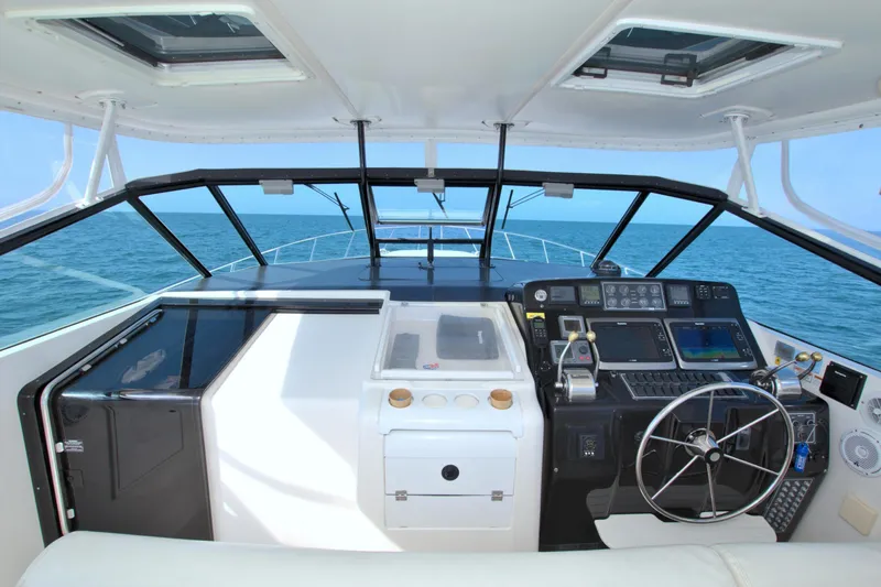 Ohana Yacht Photos Pics 2003 Tiara Yachts 4000 Express helm with ocean view, featuring modern navigation equipment.