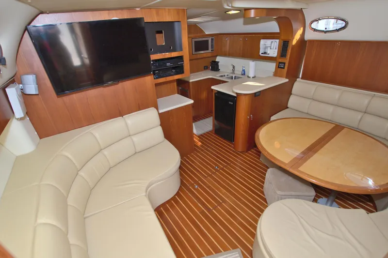 Ohana Yacht Photos Pics 2003 Tiara Yachts 4000 Express interior with leather seating, wooden flooring, and modern amenities.