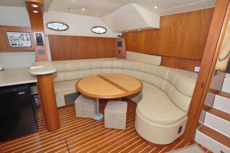 Ohana Yacht Photos Pics Luxurious interior of 2003 Tiara Yachts 4000 Express with elegant seating and wooden accents.