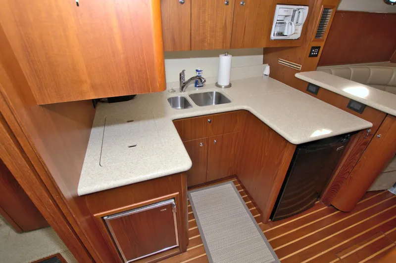 Ohana Yacht Photos Pics 2003 Tiara Yachts 4000 Express kitchen with wood cabinetry and dual sink.