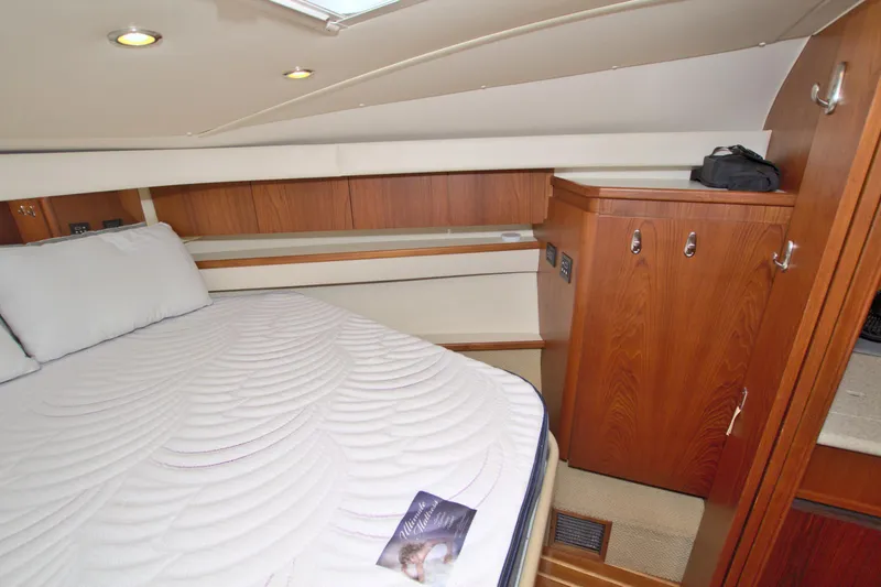 Ohana Yacht Photos Pics 2003 Tiara Yachts 4000 Express cabin with bed and wooden cabinetry.