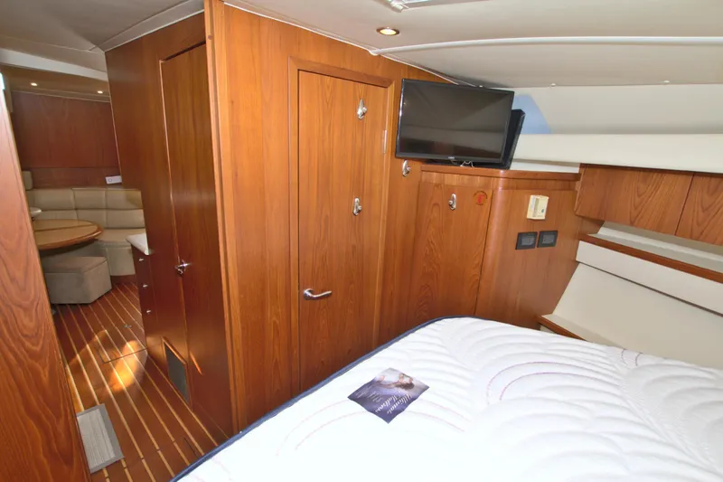 Ohana Yacht Photos Pics Interior of 2003 Tiara Yachts 4000 Express, featuring wood paneling and a cozy cabin space.