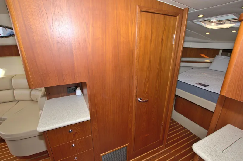 Ohana Yacht Photos Pics Interior of 2003 Tiara Yachts 4000 Express with wood paneling and cozy cabin space.