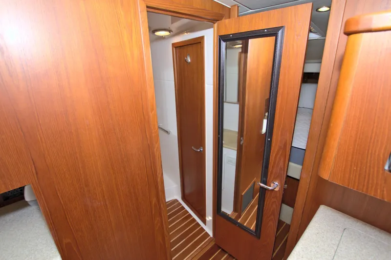 Ohana Yacht Photos Pics Interior of 2003 Tiara Yachts 4000 Express with wooden doors and mirrored panel.
