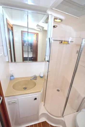 Ohana Yacht Photos Pics 2003 Tiara Yachts 4000 Express bathroom with shower, sink, and mirrored cabinet.