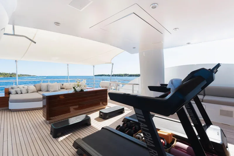 Were Dreams Yacht Photos Pics Luxurious Amels 171 yacht deck with treadmill, seating, and ocean view, 2008 model.