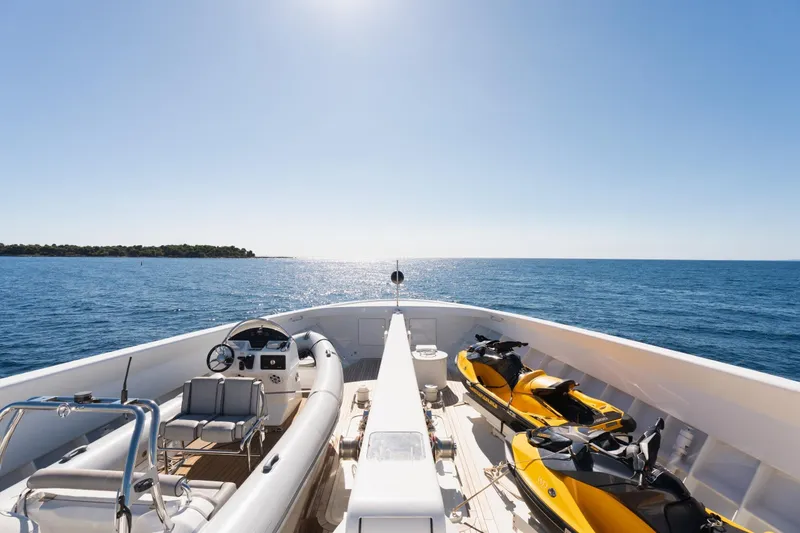 Were Dreams Yacht Photos Pics Bow view of 2008 Amels 171 Limited Edition yacht with jet skis and tender.