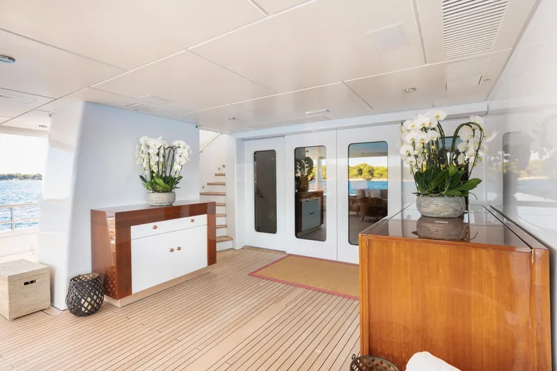 Were Dreams Yacht Photos Pics Luxurious interior of 2008 Amels 171 Limited Edition yacht with elegant decor and floral arrangements.