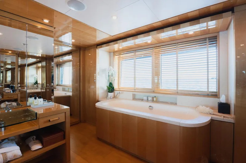 Were Dreams Yacht Photos Pics Luxurious bathroom in 2008 Amels 171 Limited Edition yacht with wooden accents and large bathtub.