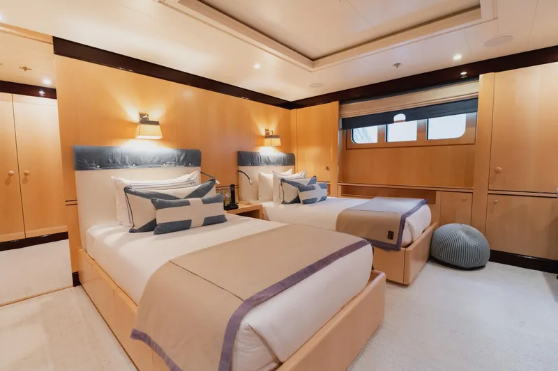 Were Dreams Yacht Photos Pics Luxurious twin bedroom on 2008 Amels 171 Limited Edition yacht, featuring elegant decor and soft lighting.