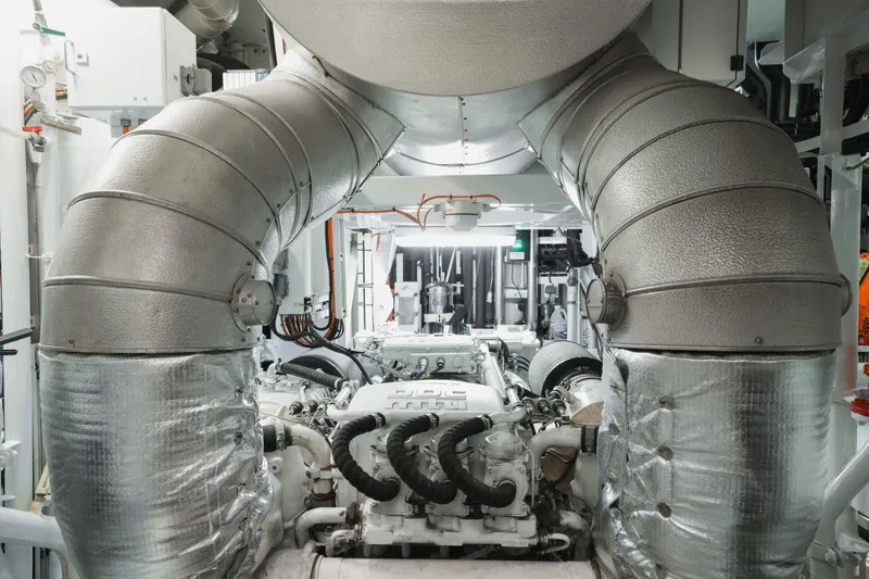 Were Dreams Yacht Photos Pics Engine room of 2008 Amels 171 Limited Edition yacht, featuring large exhaust pipes.