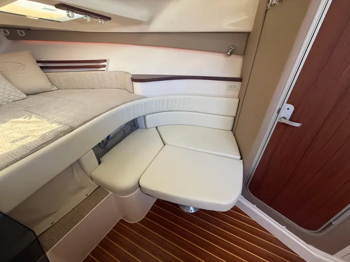  Yacht Photos Pics 2016 Grady-White Express 330 cabin interior with cushioned seating and wooden flooring.