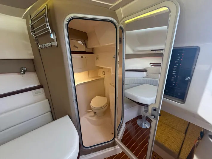  Yacht Photos Pics 2016 Grady-White Express 330 cabin interior with bathroom, seating, and wood flooring.