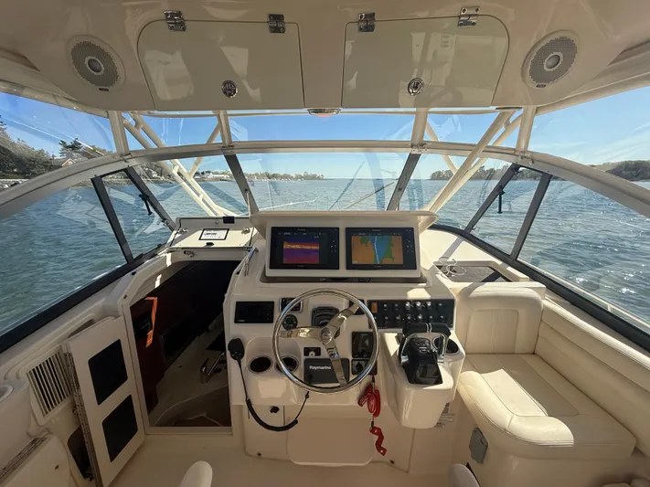  Yacht Photos Pics 2016 Grady-White Express 330 helm with dual screens, steering wheel, and comfortable seating.