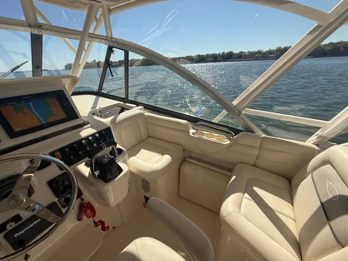  Yacht Photos Pics 2016 Grady-White Express 330 boat interior with steering wheel and navigation system.