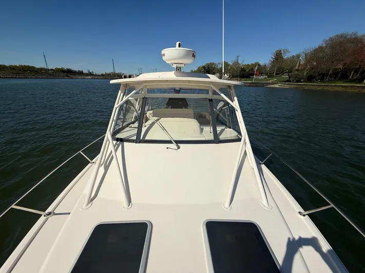 Yacht Photos Pics 2016 Grady-White Express 330 boat on calm water, clear sky background.