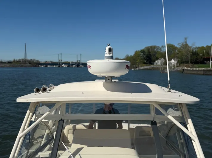  Yacht Photos Pics 2016 Grady-White Express 330 boat on water, featuring radar equipment and clear blue sky.