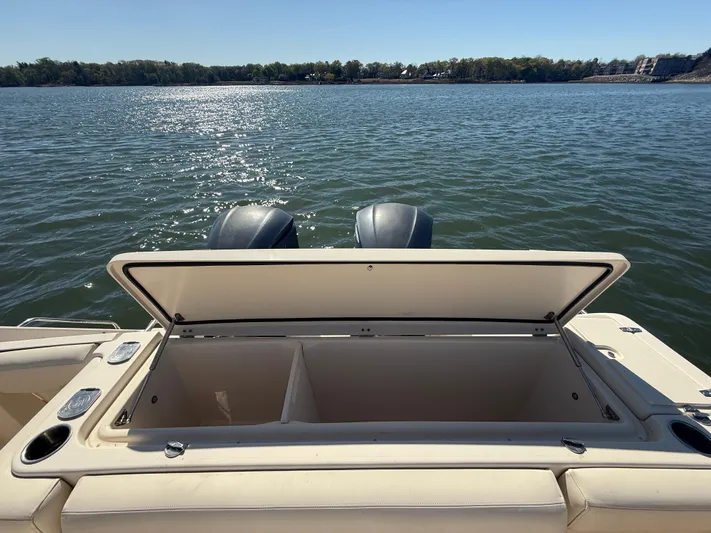  Yacht Photos Pics Open storage compartment on 2016 Grady-White Express 330 boat, overlooking serene water.