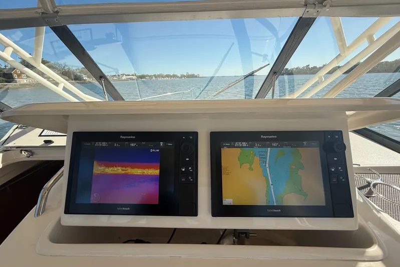  Yacht Photos Pics 2016 Grady-White Express 330 helm with dual navigation screens, overlooking calm waters.