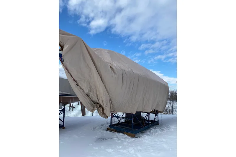  Yacht Photos Pics Covered Jeanneau Sun Odyssey 349 sailboat, 2017 model, in snowy outdoor storage.