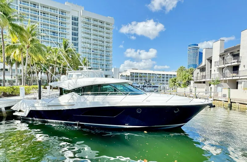 Happy Daze IV Yacht Photos Pics 2017 Tiara Yachts 53 Coupe docked in a sunny marina setting.