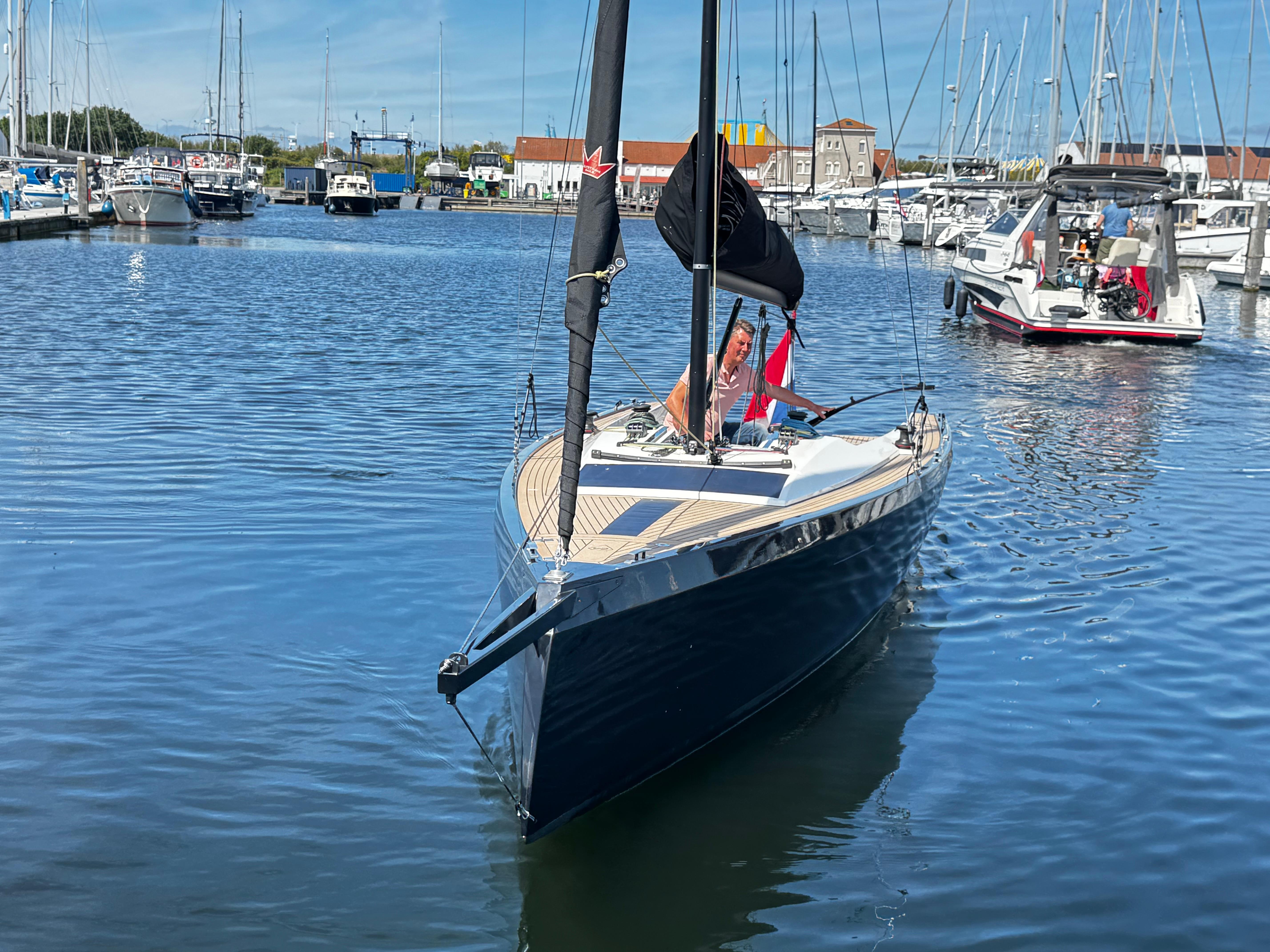 2023 Saffier SE 24 Lite sailboat in a marina, clear blue water, sunny day.