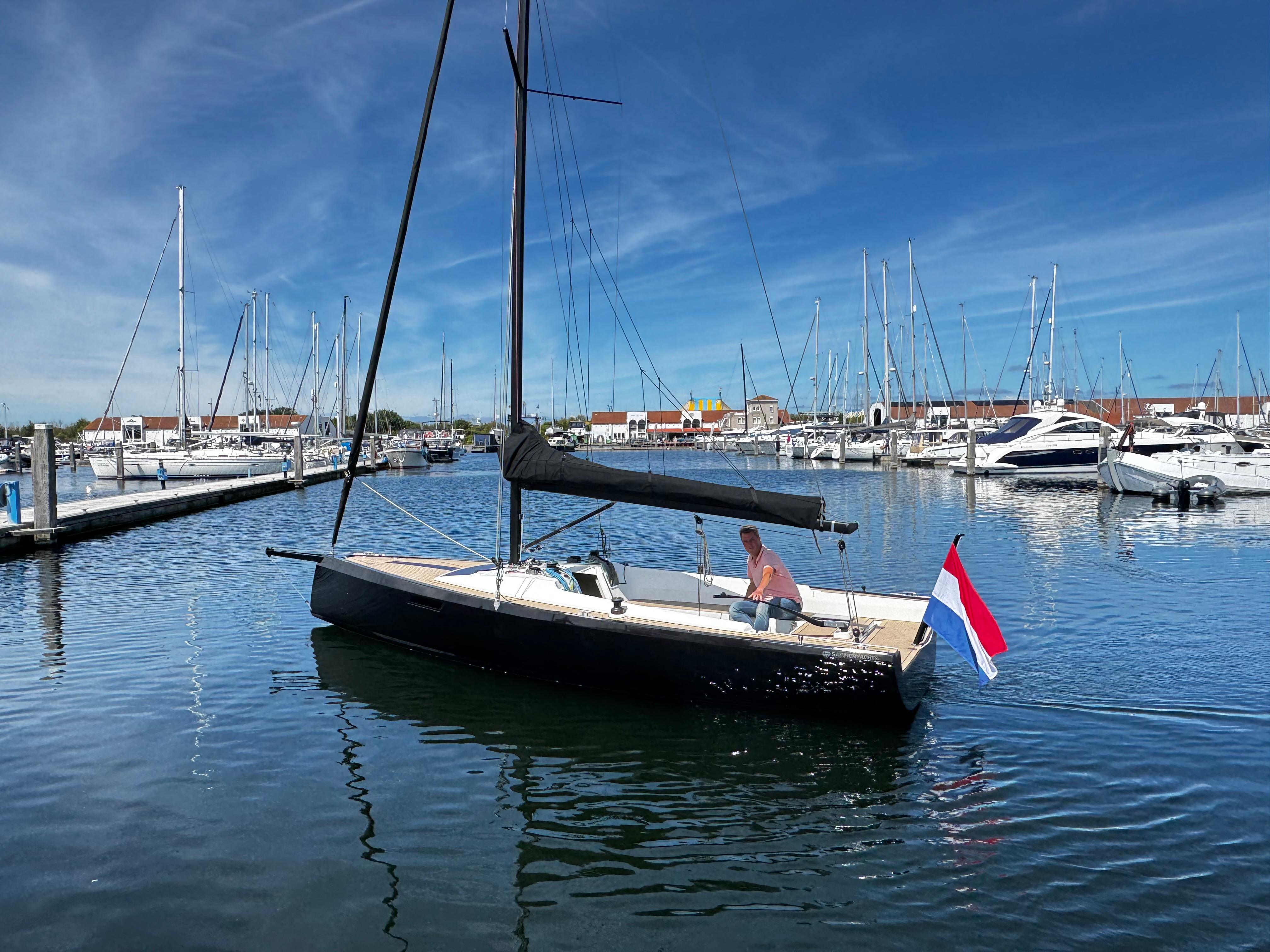 2023 Saffier SE 24 Lite sailboat in marina, clear sky, Dutch flag.