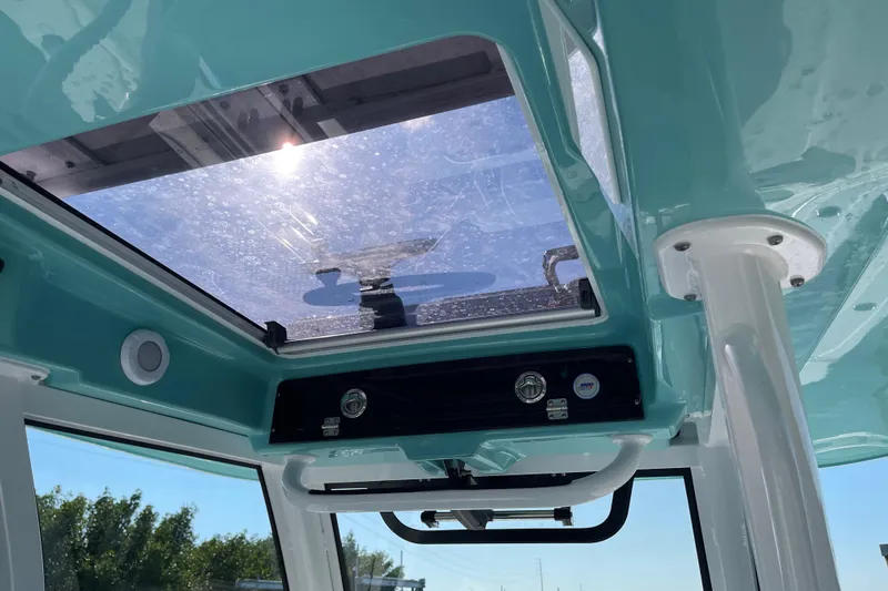  Yacht Photos Pics 2025 Sportsman Open 302 Center Console boat interior with sunroof and teal accents.