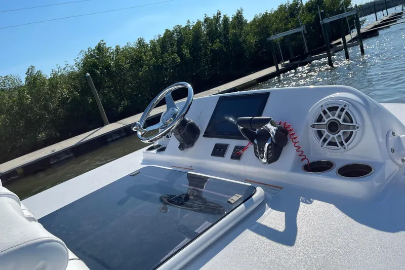  Yacht Photos Pics 2025 Sportsman Open 302 Center Console boat dashboard with steering wheel and controls.