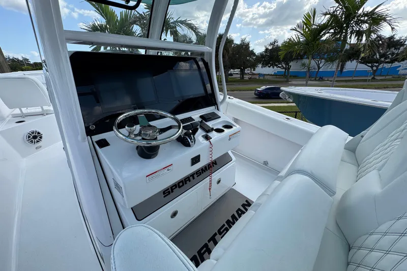  Yacht Photos Pics 2025 Sportsman Open 302 Center Console boat interior with steering wheel and seating.