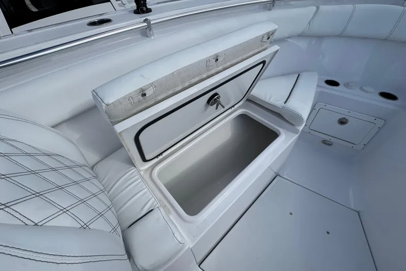  Yacht Photos Pics 2025 Sportsman Open 302 Center Console boat with open storage compartment and cushioned seating.