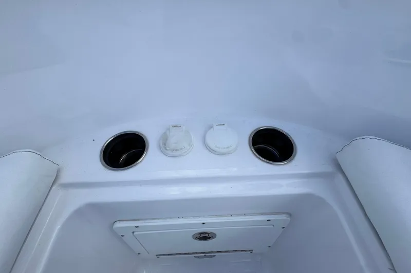  Yacht Photos Pics 2025 Sportsman Open 302 Center Console boat interior with cup holders and storage compartment.