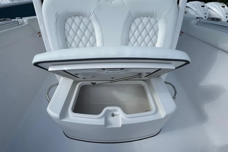  Yacht Photos Pics 2025 Sportsman Open 302 Center Console seat with storage compartment open.