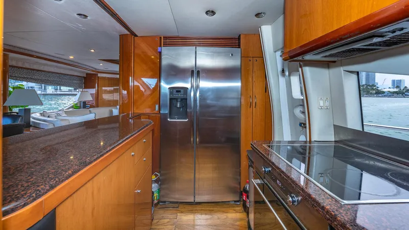 Iconic Yacht Photos Pics Luxurious kitchen interior of 2003 Sunseeker 82 Yacht with modern appliances and wood finishes.