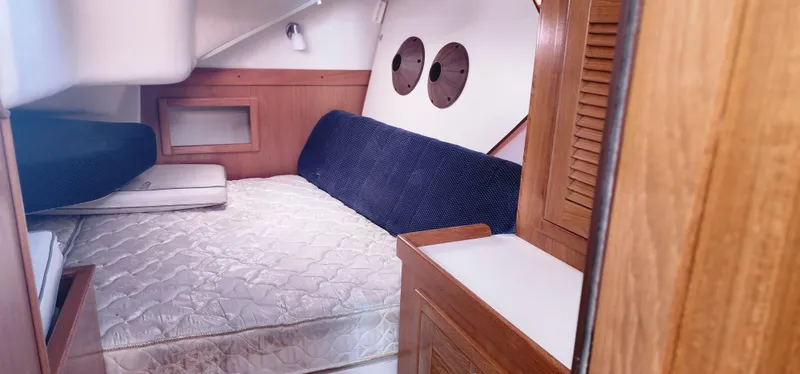 Janice Marie Yacht Photos Pics Interior cabin of 2004 Catalina 350 Sloop with bed and wooden cabinetry.