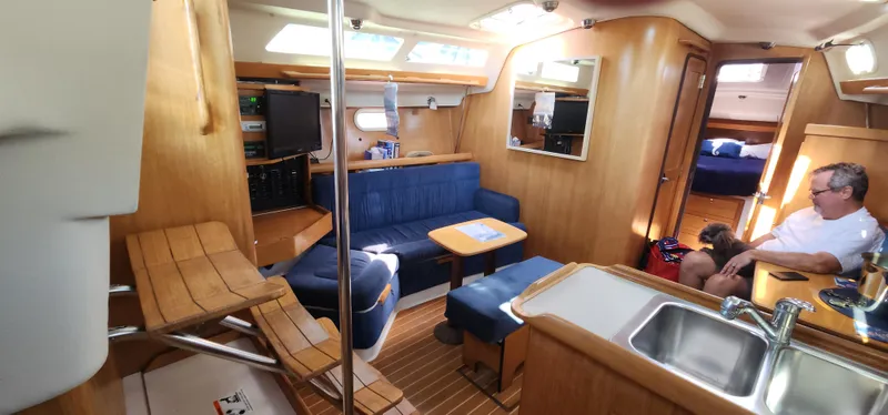 Janice Marie Yacht Photos Pics Interior of 2004 Catalina 350 Sloop sailboat with seating, table, and kitchenette.