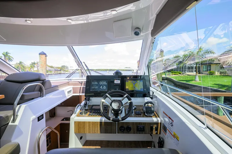 Ajac Cruiser Yacht Photos Pics 2015 Cruisers Cantius yacht helm with modern controls and waterfront view.