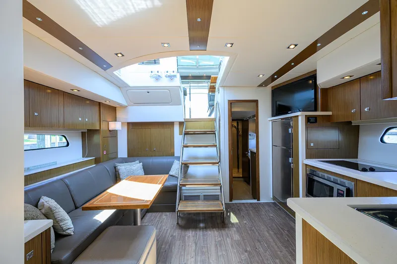 Ajac Cruiser Yacht Photos Pics Luxurious interior of 2015 Cruisers Cantius yacht with modern kitchen and dining area.