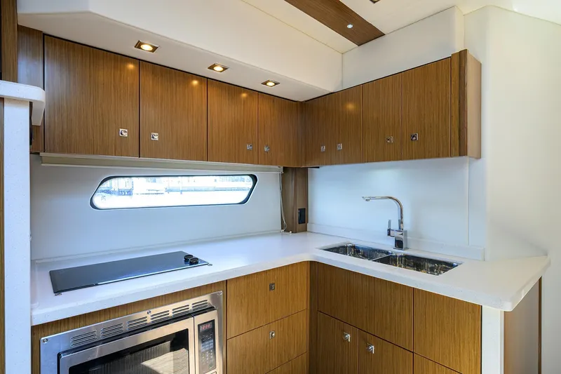 Ajac Cruiser Yacht Photos Pics Luxurious 2015 Cruisers Cantius yacht kitchen with modern wood cabinetry and sleek appliances.