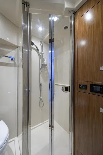 Ajac Cruiser Yacht Photos Pics 2015 Cruisers Cantius yacht bathroom with glass shower and wooden cabinetry.